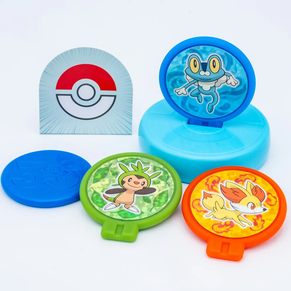 The Target Hockey toy set up for play, with the disc aimed at the Poké Ball target across a tabletop